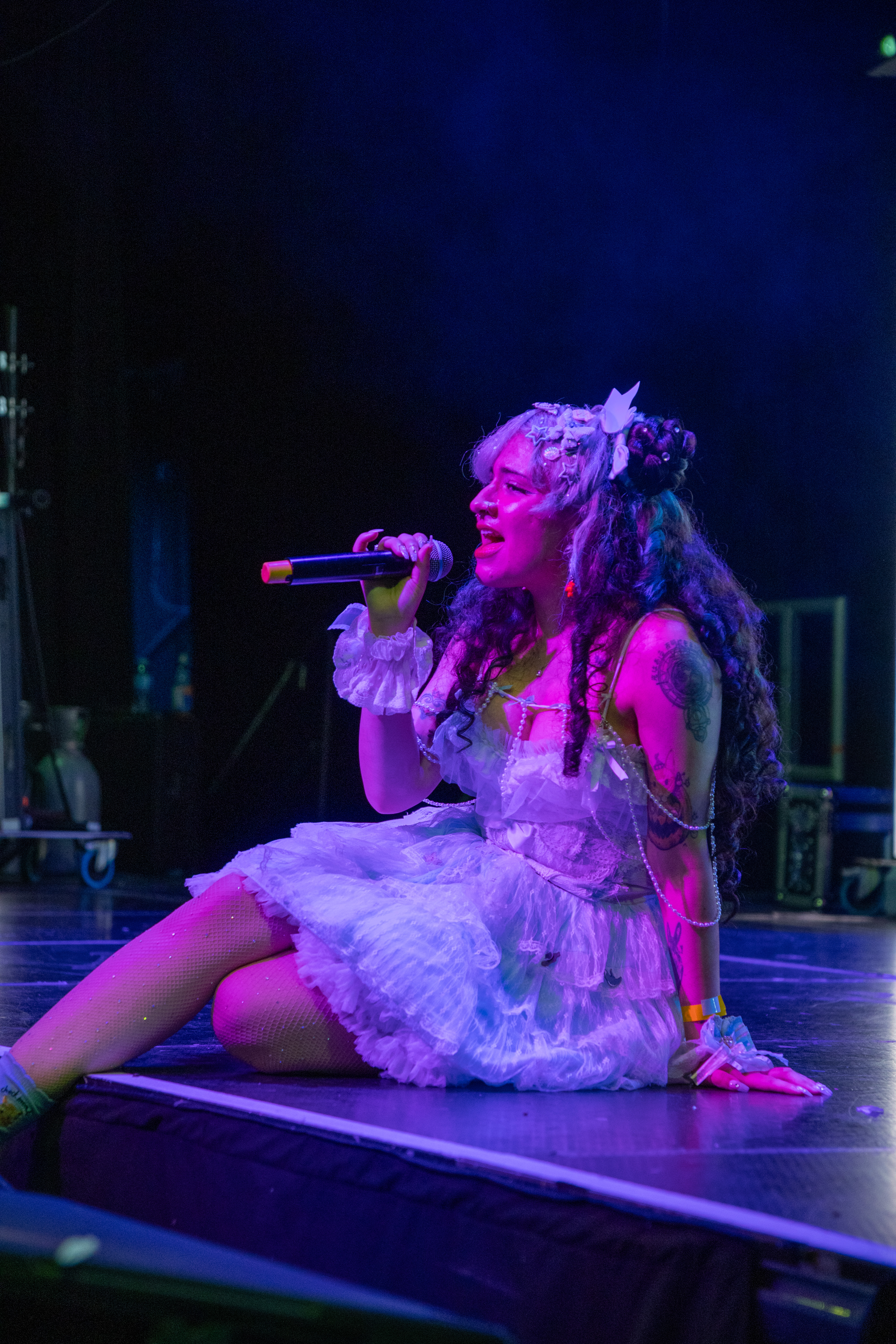 Vocalist mid-set under stage lights